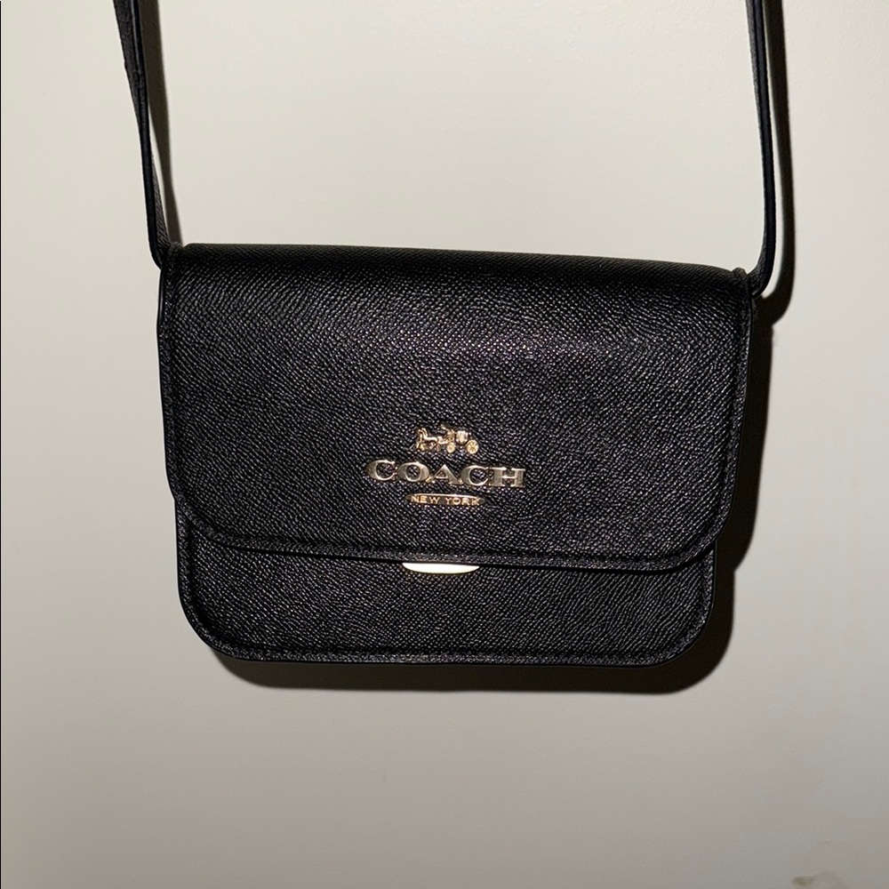 Coach Black Crossbody Bag with Gold Hardware and Flap Closure